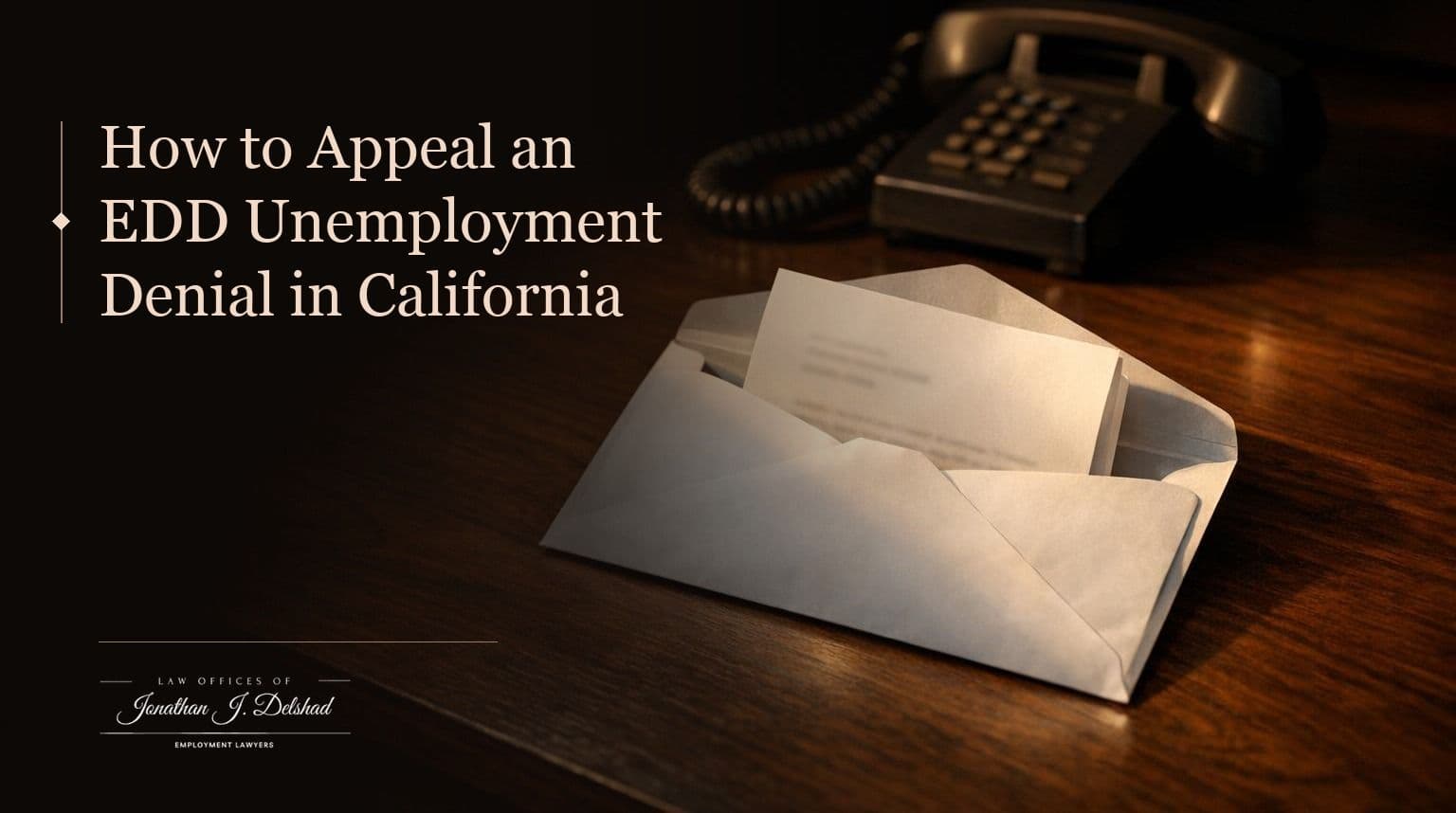 An opened envelope with a folded letter on a dark wooden desk beside a desk telephone